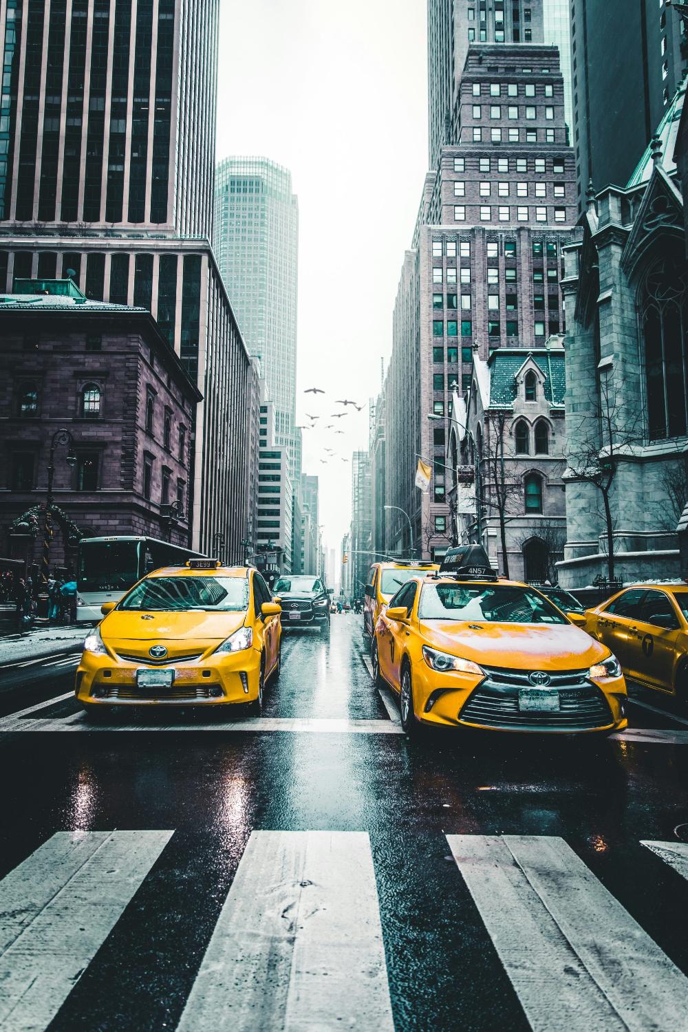 Yellow taxis parked on street

